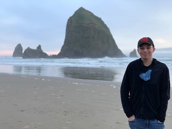 Kyle standing on the beach in front of Haystack rock
