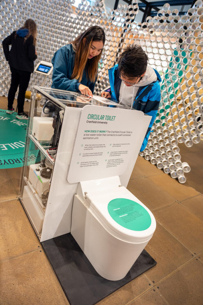 Visitors observe the Cranfield toilet prototype at the Discovery Center.