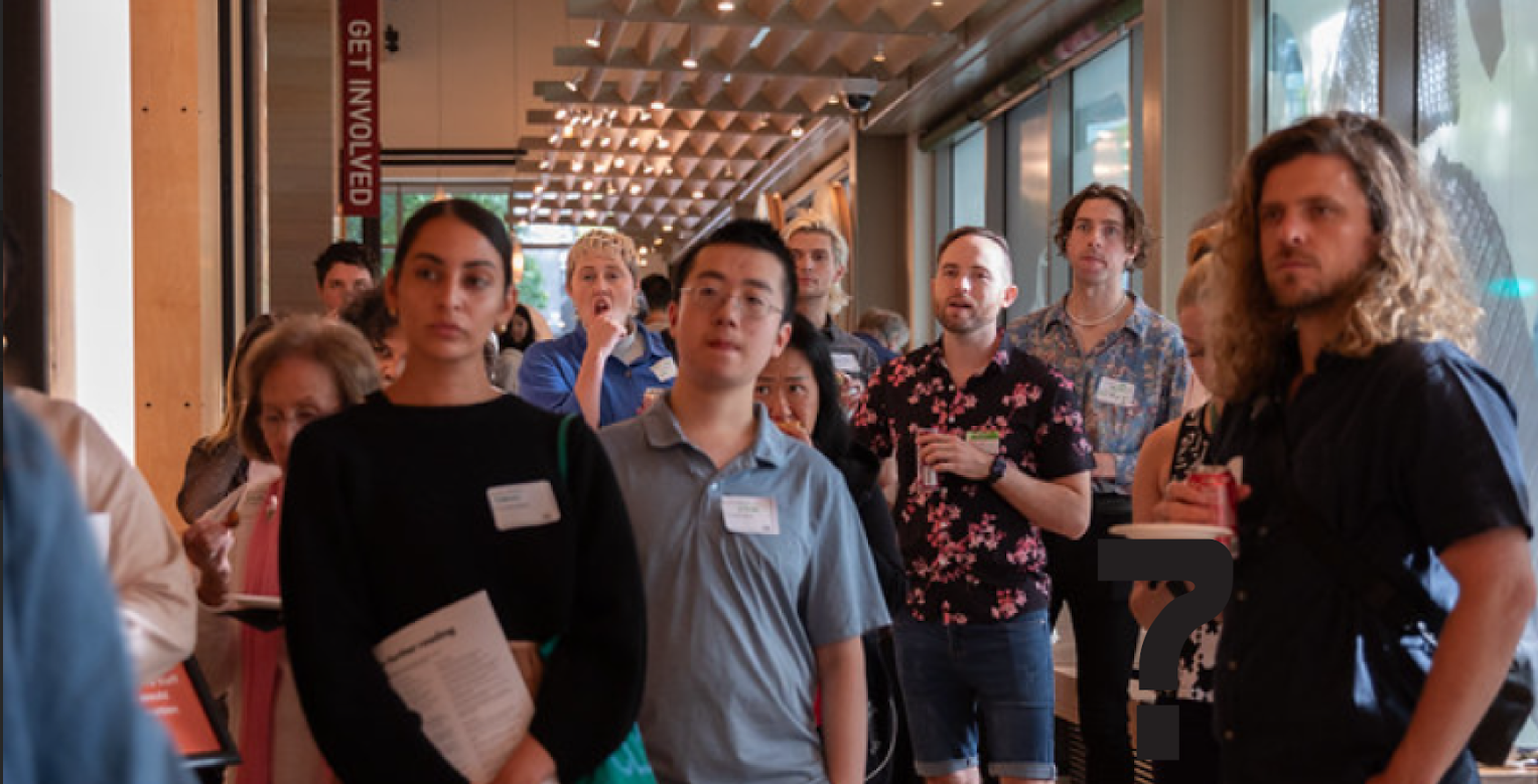 A group of Seattle Design Festival guest tour the Discovery Center galleries.