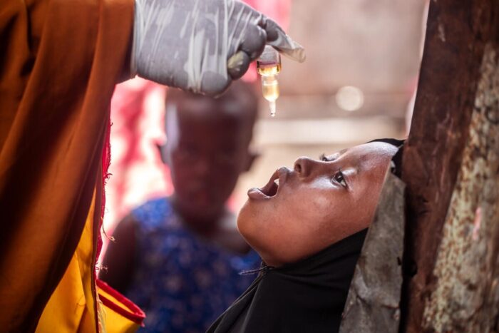 Child is administered an oral polio vaccine.