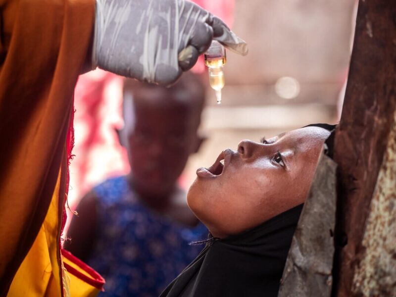 Child is administered an oral polio vaccine.