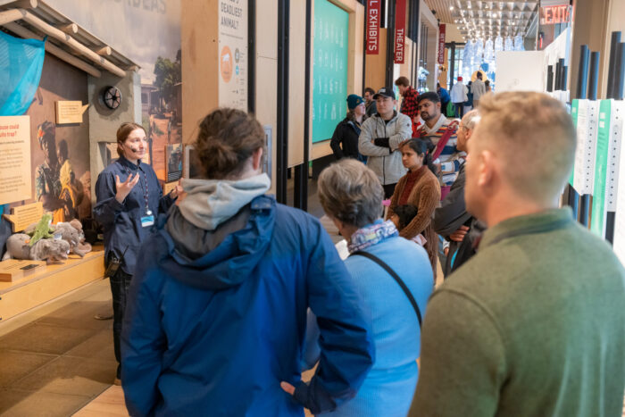 Staff members leads a tour discussing the importance of mosquito nets in protecting from NTDs.