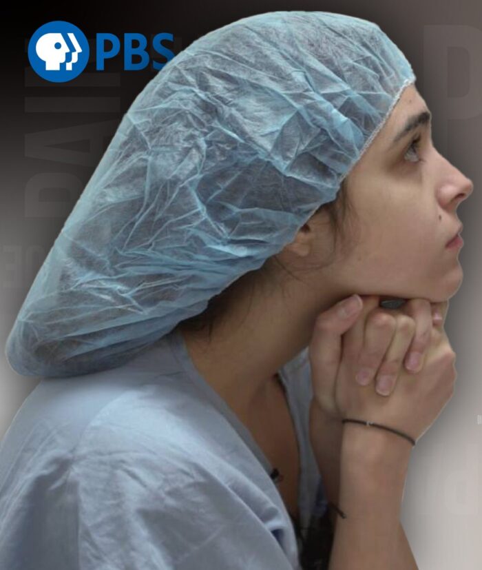 Female patient waits with surgical cap over her hair.